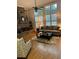 Cozy living room with a stone fireplace, hardwood floors, and bright windows at 388 Golf Crest Dr, Acworth, GA 30101