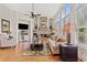 Cozy living room with a stone fireplace, hardwood floors, and large windows with plantation shutters at 388 Golf Crest Dr, Acworth, GA 30101