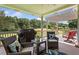 Relaxing outdoor patio with comfortable seating, grill, and a view of the serene backyard at 388 Golf Crest Dr, Acworth, GA 30101