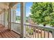 Exterior porch featuring classic white columns, brick flooring, and mature landscaping at 388 Golf Crest Dr, Acworth, GA 30101