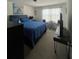 Comfortable bedroom with a full-size bed, television, and natural light at 7699 Cabrini Pl, Fairburn, GA 30213