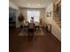 Bright dining room with hardwood floors and a round glass table at 7699 Cabrini Pl, Fairburn, GA 30213