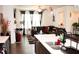 Open-concept living room featuring modern decor and dark-toned sectional sofa at 7699 Cabrini Pl, Fairburn, GA 30213