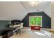 Finished attic space with office and desk and storage chest in view of window at 891 Paoli Se Ave, Atlanta, GA 30316