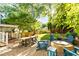 Spacious backyard with an outdoor dining area, fire pit, and lush landscaping, ideal for outdoor living at 891 Paoli Se Ave, Atlanta, GA 30316