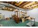 Unfinished basement area featuring exposed beams, ductwork, and green tile flooring at 891 Paoli Se Ave, Atlanta, GA 30316