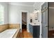 Bathroom with soaking tub and a vanity with generous storage at 891 Paoli Se Ave, Atlanta, GA 30316