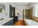 Bathroom featuring a soaking tub, glass shower, and modern fixtures at 891 Paoli Se Ave, Atlanta, GA 30316