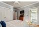 Bright bedroom features a ceiling fan, tv, closet, and door to an outdoor patio space at 891 Paoli Se Ave, Atlanta, GA 30316