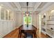 Bright dining room with hardwood floors, built-in cabinets, coffered ceiling, and french doors leading to the backyard at 891 Paoli Se Ave, Atlanta, GA 30316