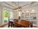Formal dining room featuring stylish lighting, built-in shelving, and backyard access at 891 Paoli Se Ave, Atlanta, GA 30316