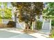 View of garage and staircase leading to multi-level deck of two-story home with mature tree in the front yard at 891 Paoli Se Ave, Atlanta, GA 30316