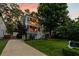 Exterior of home at dusk, featuring double decks, green lawn and mature trees at 891 Paoli Se Ave, Atlanta, GA 30316