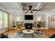 Spacious living room with coffered ceilings, a fireplace, built-in shelving, and hardwood flooring at 891 Paoli Se Ave, Atlanta, GA 30316