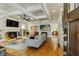 Open-concept living room featuring a fireplace, hardwood floors, and a coffered ceiling at 891 Paoli Se Ave, Atlanta, GA 30316