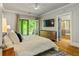 Bedroom boasts hardwood floors, balcony access, and en-suite bathroom with a glass shower and soaking tub at 891 Paoli Se Ave, Atlanta, GA 30316
