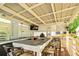A well-equipped outdoor kitchen with a built-in grill, bar seating, and a mounted TV at 891 Paoli Se Ave, Atlanta, GA 30316