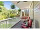 Relaxing covered porch view with chairs, swing, and hanging plants overlooking the lawn at 891 Paoli Se Ave, Atlanta, GA 30316