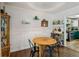 Dining area featuring hardwood floors, decorative shelves, wainscoting, and an adjacent kitchen at 1410 Cobb Branch Dr, Decatur, GA 30032