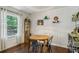 Charming dining area featuring a round table, hardwood floors, wainscoting, and natural light at 1410 Cobb Branch Dr, Decatur, GA 30032