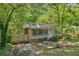 A charming single-story home featuring a welcoming front entrance, covered carport, and lush green surroundings at 1410 Cobb Branch Dr, Decatur, GA 30032