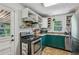 Efficient kitchen with stainless steel appliances, green cabinets, and functional storage solutions at 1410 Cobb Branch Dr, Decatur, GA 30032