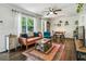 Open living room featuring hardwood floors, natural light, wainscoting, and a comfortable seating area at 1410 Cobb Branch Dr, Decatur, GA 30032