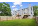 Spacious backyard with privacy fence, stairs to deck, and lush green lawn at 4044 Spring Cove Dr, Duluth, GA 30097