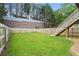 Large, level backyard with new fencing and wooden staircase leading to upper level at 4044 Spring Cove Dr, Duluth, GA 30097