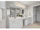 Bathroom showcasing double sink vanity with large mirror and decorative lighting at 4044 Spring Cove Dr, Duluth, GA 30097