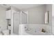 Relaxing bathroom featuring a soaking tub with white tile surround and glass enclosed shower at 4044 Spring Cove Dr, Duluth, GA 30097
