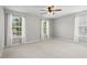 Bedroom features plush carpet, gray paint, and natural light from two large windows at 4044 Spring Cove Dr, Duluth, GA 30097