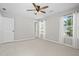 Bright, carpeted bedroom with ceiling fan and two windows with natural light at 4044 Spring Cove Dr, Duluth, GA 30097