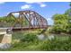 Charming steel bridge over a waterway provides access to walking trails and community amenities at 4044 Spring Cove Dr, Duluth, GA 30097