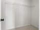A small closet with white walls, a single wire shelf, and neutral carpeting at 4044 Spring Cove Dr, Duluth, GA 30097