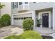 Inviting home exterior featuring a garage, manicured bushes, and a welcoming entrance at 4044 Spring Cove Dr, Duluth, GA 30097