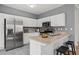 Kitchen with stainless steel appliances, white cabinets, and a breakfast bar at 4044 Spring Cove Dr, Duluth, GA 30097
