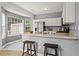 Modern kitchen with white cabinetry, gray walls, and an eat-in bar area at 4044 Spring Cove Dr, Duluth, GA 30097