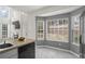 Sunlit eat-in kitchen area with large windows, tile floor, and stainless steel appliances at 4044 Spring Cove Dr, Duluth, GA 30097