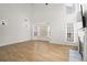 Sunlit living room with a fireplace, large windows, and hardwood floors at 4044 Spring Cove Dr, Duluth, GA 30097