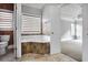 Bathroom with a soaking tub and view into bedroom at 740 Creek Wind Ct, Duluth, GA 30097