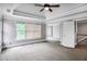 Light-filled bedroom with tray ceilings, plush carpet, and large windows at 740 Creek Wind Ct, Duluth, GA 30097