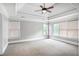 Spacious bedroom with tray ceilings, neutral carpet, and large windows at 740 Creek Wind Ct, Duluth, GA 30097