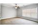 Bedroom featuring a ceiling fan, large windows, and neutral walls and carpet at 740 Creek Wind Ct, Duluth, GA 30097