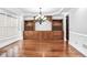 Open dining room featuring hardwood floors, built-in shelving, and decorative lighting at 740 Creek Wind Ct, Duluth, GA 30097