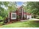 Beautiful two-story brick home with a well-manicured lawn and mature trees at 740 Creek Wind Ct, Duluth, GA 30097