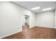 Open living room with neutral paint, wood floors, and a view to other rooms at 740 Creek Wind Ct, Duluth, GA 30097