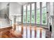 Bright living room featuring hardwood floors, a fireplace, and expansive windows at 740 Creek Wind Ct, Duluth, GA 30097