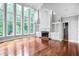 Bright living room featuring hardwood floors, a fireplace, and expansive windows at 740 Creek Wind Ct, Duluth, GA 30097