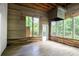 Spacious sunroom with wood paneling, tiled floor, and windows offering natural light at 740 Creek Wind Ct, Duluth, GA 30097